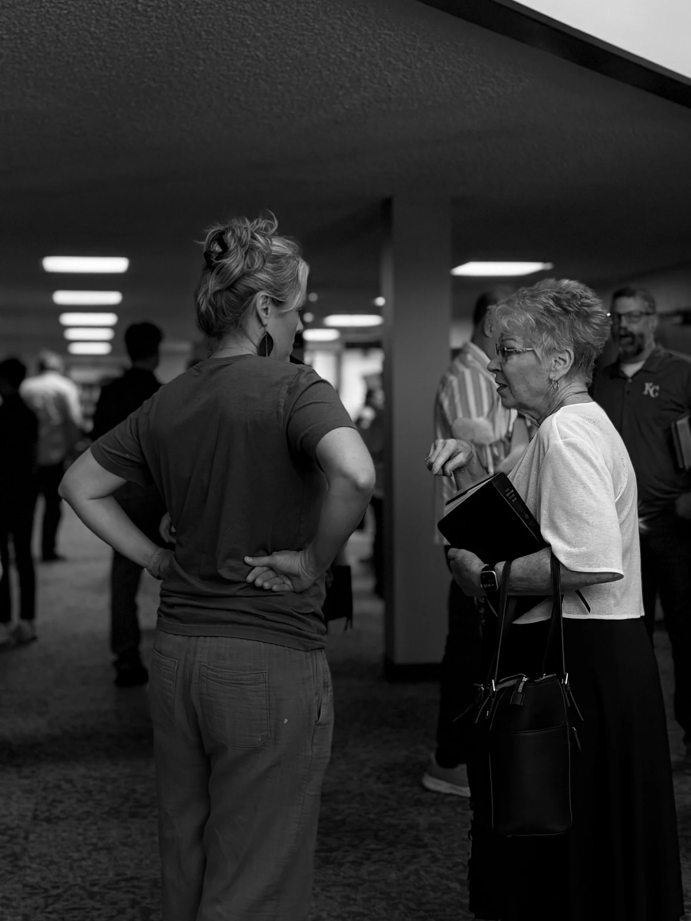 A candid conversation between people at Country Acres Baptist Church